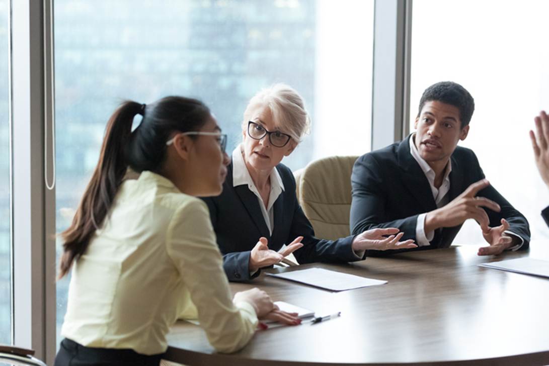 A group of people sitting around a table
AI-generated content may be incorrect.